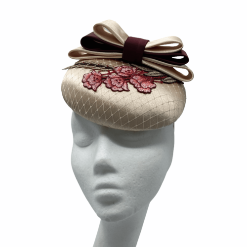 Cream base headpiece with cream/burgundy bow and red flower motif detail.