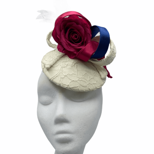 Cream lace based headpiece with pink and navy swirl detail.