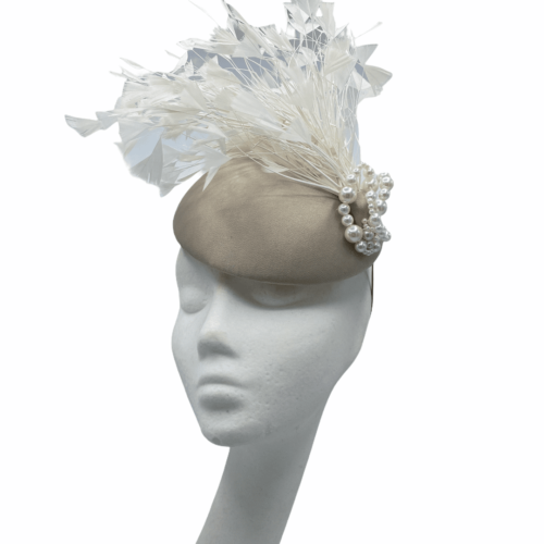 Taupe base coloured headpiece with an array of white feathers and stunning pearl detail.