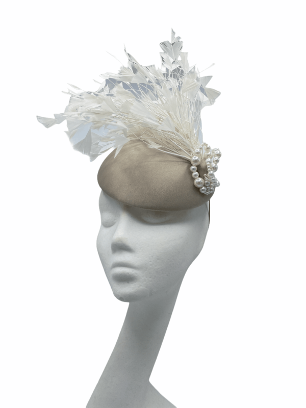 Taupe base coloured headpiece with an array of white feathers and stunning pearl detail.