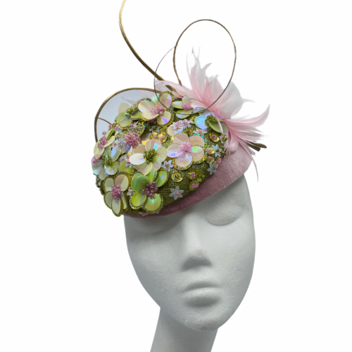 Pink small base headpiece with green & pink flower detail and finished with gold quills .