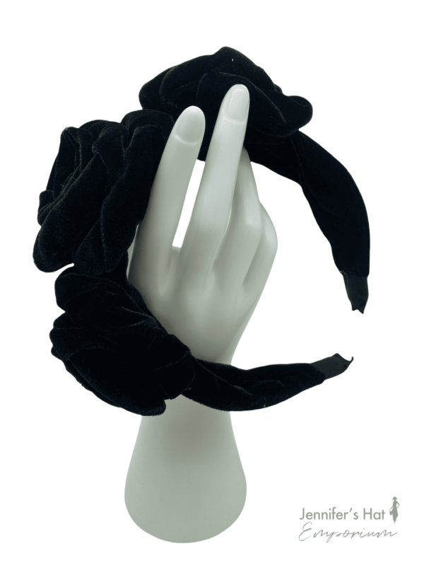 Black velvet headband with 3 beautiful flower twirls.