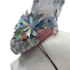 Silver jewel embellished headpiece with iridescent flower detail.