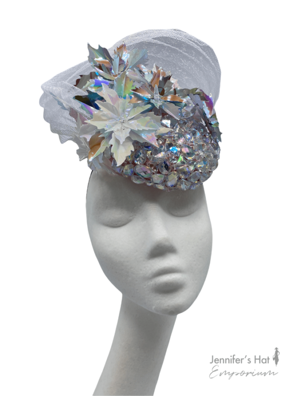 Silver jewel embellished headpiece with iridescent flower detail.