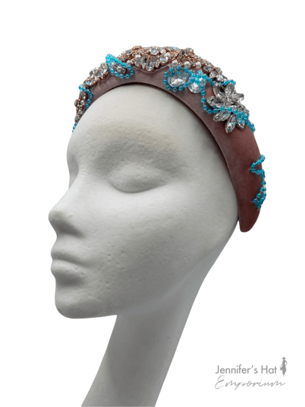Pink millinery made headband crown with clear stone and gold embellishment and aqua blue beading.