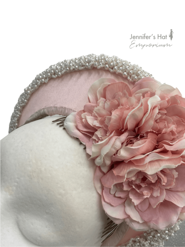 Stunning baby pink halo crown encrusted with pearls and flower detail.