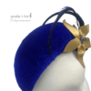 Blue bandeau crown with gold flower detail.
