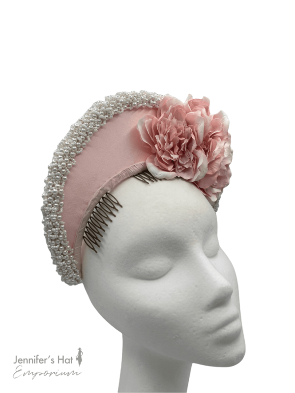 Stunning baby pink halo crown encrusted with pearls and flower detail.