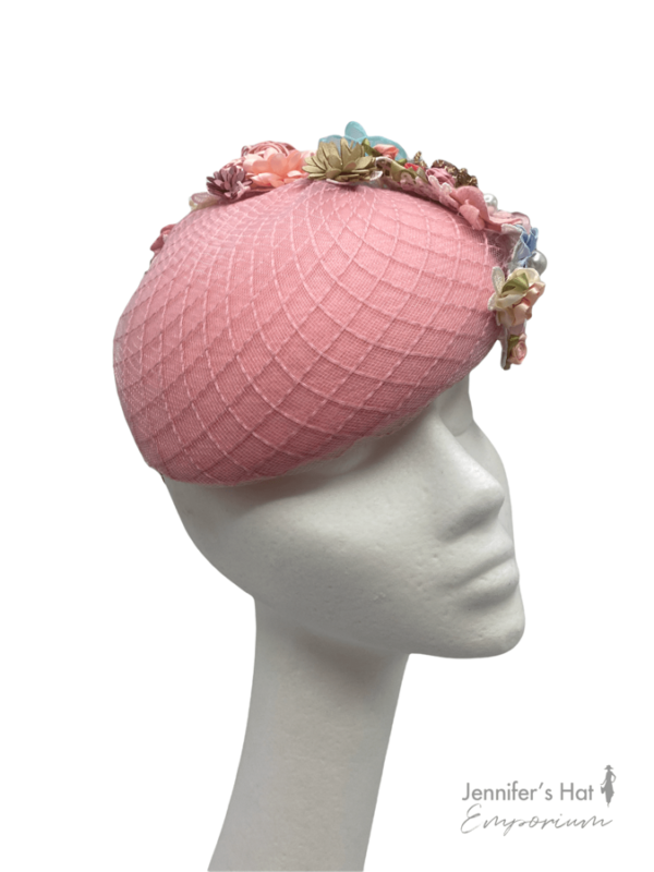 Pink teardrop headpiece with an array of coloured detail to rear of the headpiece.