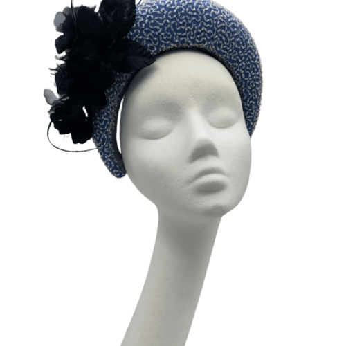 Stunning cornflower blue crown with hand beaded detail and black flower to one side.