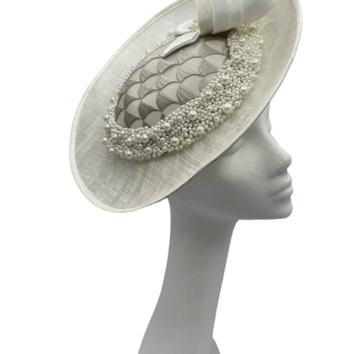 Ivory side saucer disc headpiece, ivory/taupe satin swirl detail to the top. Ivory headband with taupe patterned detail to the side surrounded with pearls.