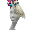 Beautiful cream side saucer disc headpiece, cream/turquoise/pink satin swirl detail to the top finished with spray of pink feather detail. Cream headband with cream circular lace detail to the side surrounded with pearls.
