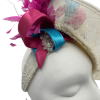 Beautiful cream side saucer disc headpiece, cream/turquoise/pink satin swirl detail to the top finished with spray of pink feather detail. Cream headband with cream circular lace detail to the side surrounded with pearls.