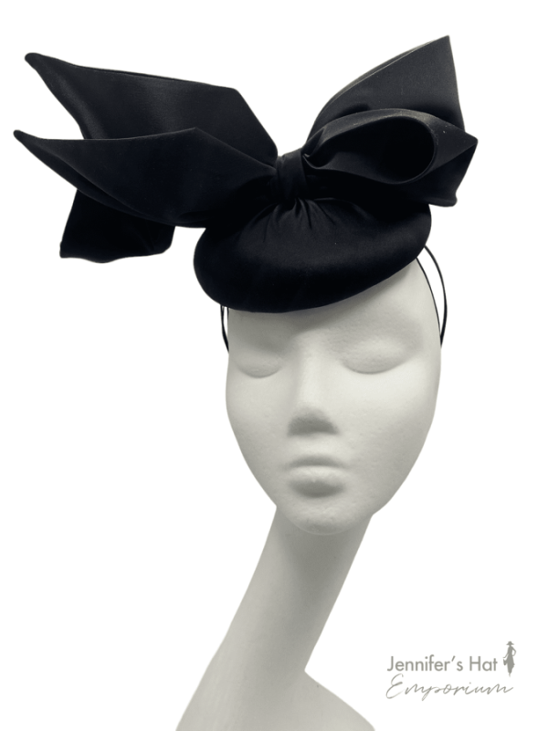 Stunning black satin headpiece with with the most beautiful bow detail on a headband and elastic for extra security.