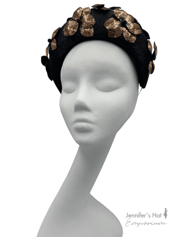 Black bandeau crown with rose gold flower petal detail.
