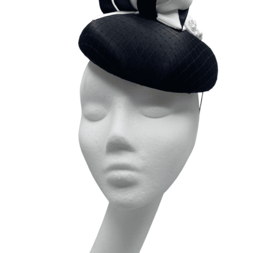 Black satin headpiece with black/white swirl detail and pearls to finish. 
