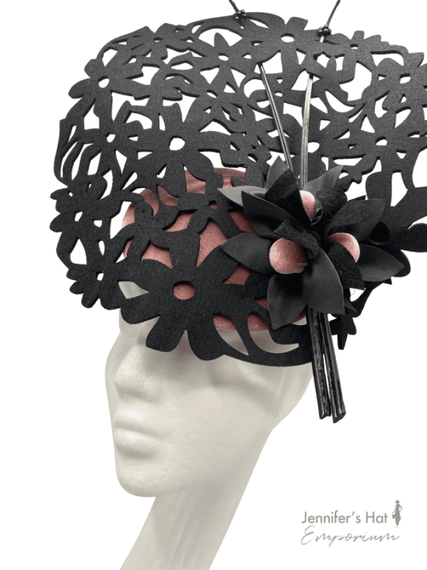 Black laser cut detail striking headpiece with blush velvet base.