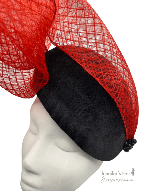 Black velvet percher with red crin swirl from side to top and finished with black bead detail to the base of the red crin.