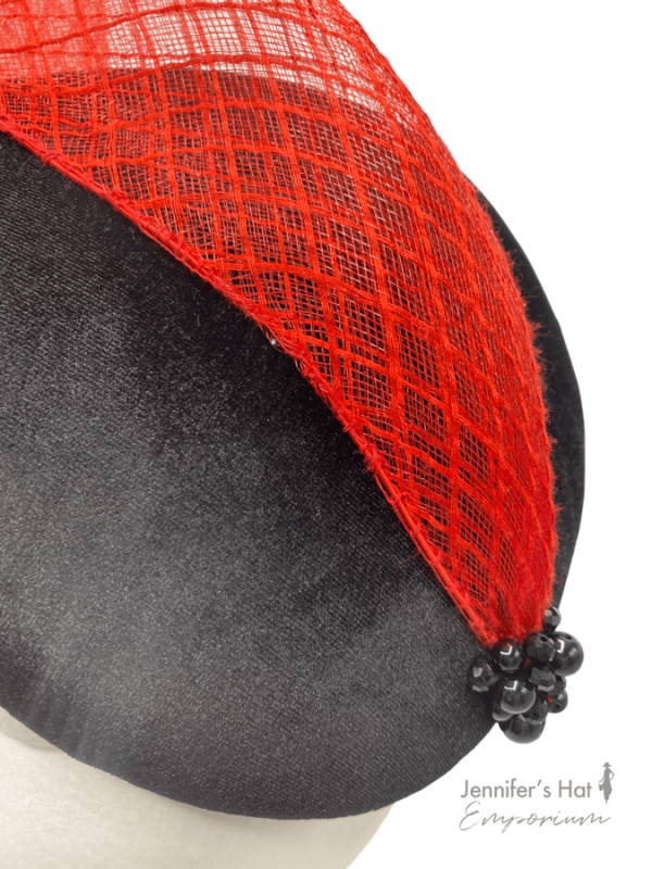 Black velvet percher with red crin swirl from side to top and finished with black bead detail to the base of the red crin.