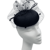 Black headpiece with black polka dot veiling detail to the top.