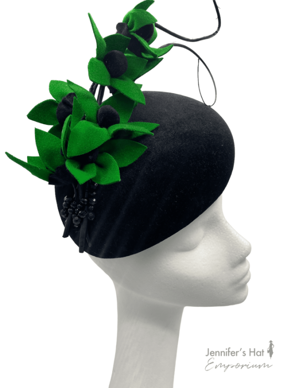 Large black velvet teardrop with handmade green felt flower detail. Stunning headpiece.