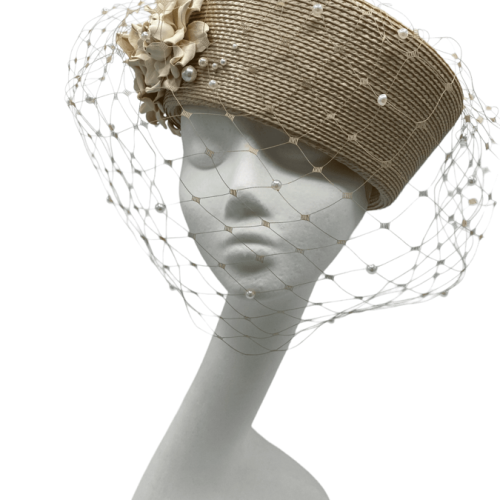 Beige coloured headpiece with pearl encrusted full face veiling.