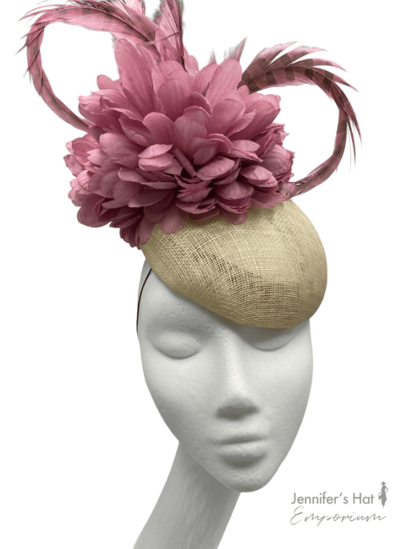 Cream/beige base with pink feathers and flowers to top.