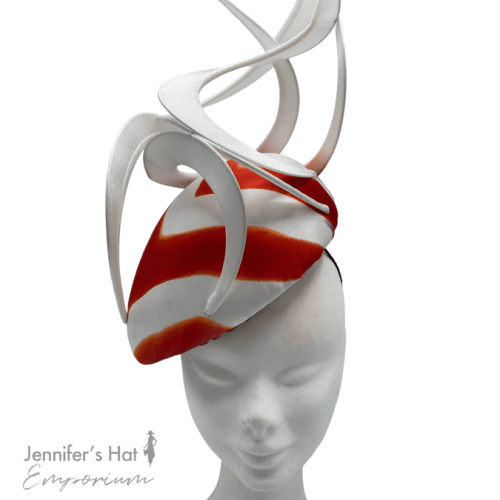 Large white teardrop headpiece with white swirl detail, finished with a stripe effect in the colour orange/red.