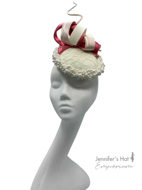 Ivory headpiece with lace centre, finished with ivory and coral swirl detail.