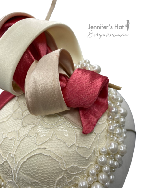 Ivory headpiece with lace centre, finished with ivory and coral swirl detail.