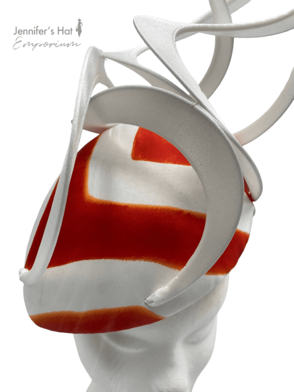 Large white teardrop headpiece with white swirl detail, finished with a stripe effect in the colour orange/red.