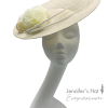 Large ivory side saucer headpiece with pom pom detail and matching coloured quill to finish.