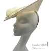 Large ivory side saucer headpiece with pom pom detail and matching coloured quill to finish.