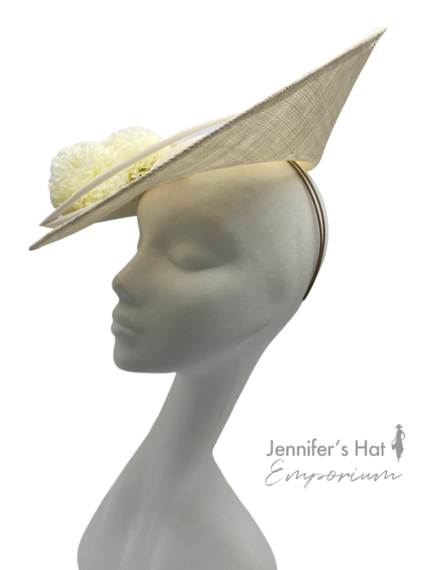 Large ivory side saucer headpiece with pom pom detail and matching coloured quill to finish.