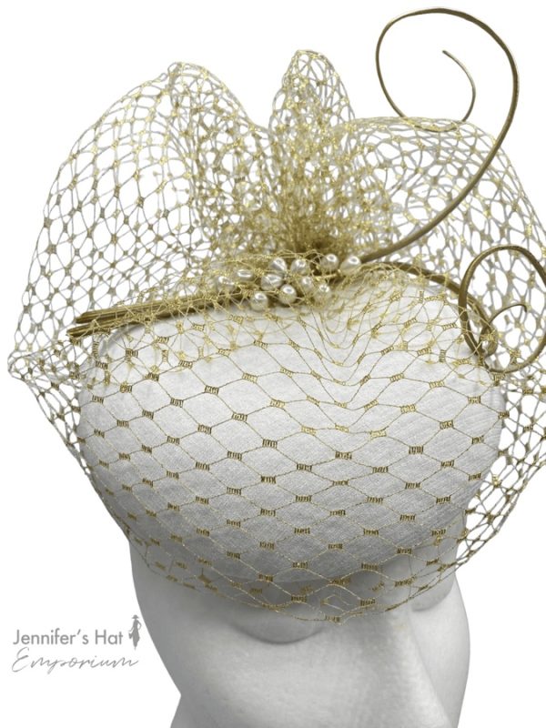 Winter ivory white headpiece with gold veiling and gold quills, finished with pearl embellished detail.