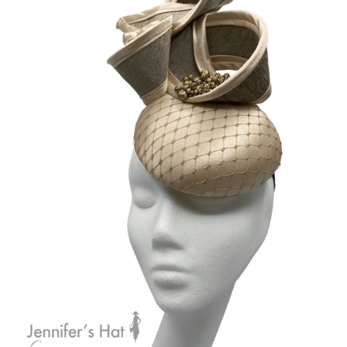 Gold satin headpiece with gold and cream swirl detail.