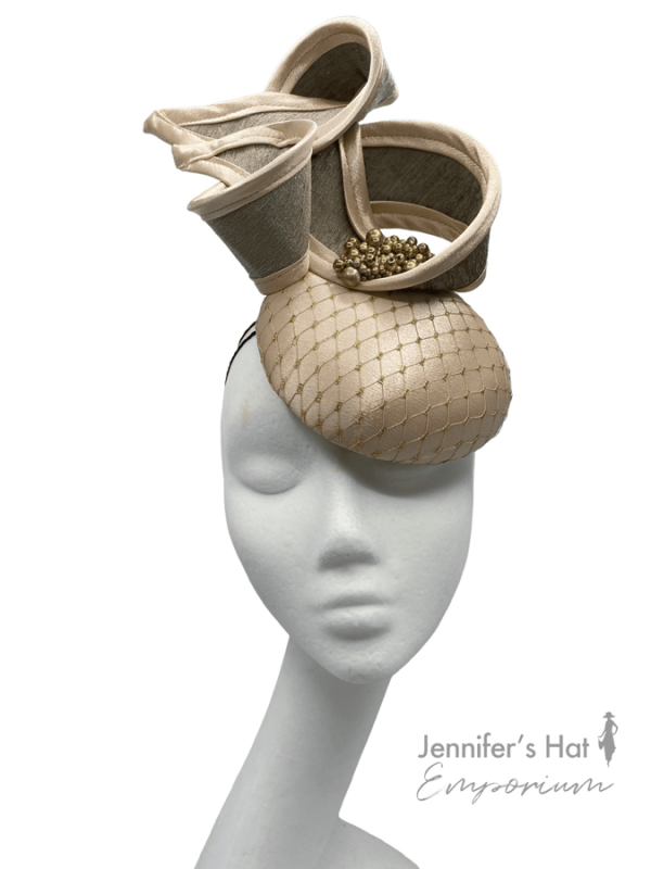 Gold satin headpiece with gold and cream swirl detail.