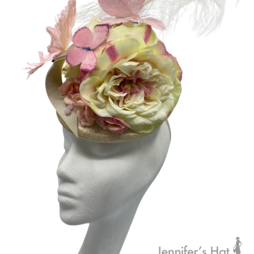 Cream base with cream flowers and beautiful pink butterflies with cream leather swirl detail. Large cream feather that rises up from the back of the headpiece.