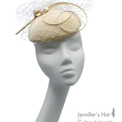 Cream based headpiece with beautiful white veiled detail and small pearl embellishment.