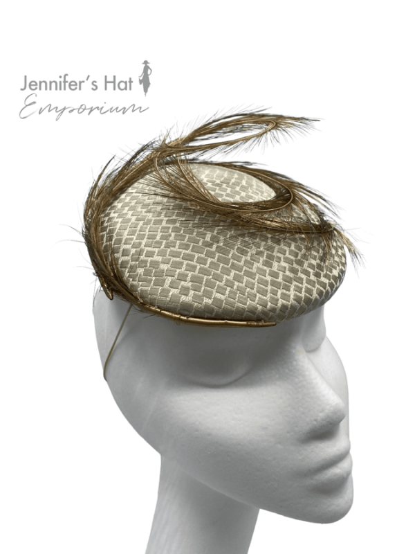Beige/taupe headpiece with gold feather detail to finish.