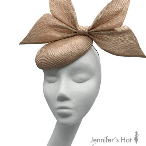 Peach coloured cocktail headpiece made from parasisal straw with beautiful side bow detail.