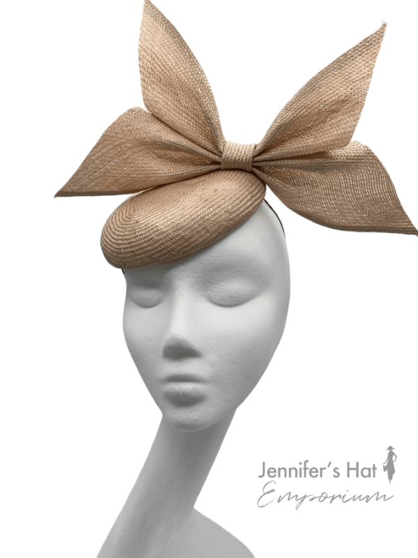 Peach coloured cocktail headpiece made from parasisal straw with beautiful side bow detail.