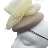 Taupe based headpiece with cream crin detail, finished with pearl decor and cream quill.