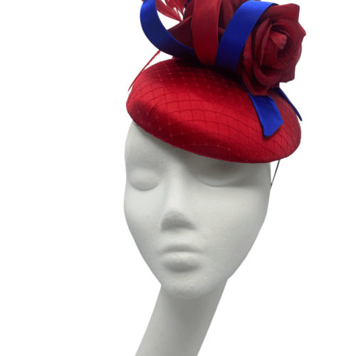 Stunning red satin headpiece with red flowers and royal blue swirl detail.