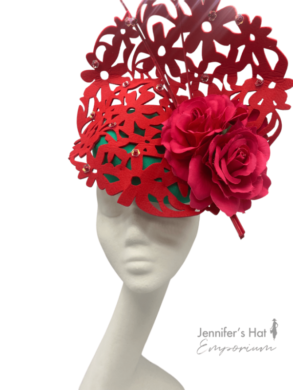 Red laser cut headpiece with emerald green base, perfect hat for colour clashing.