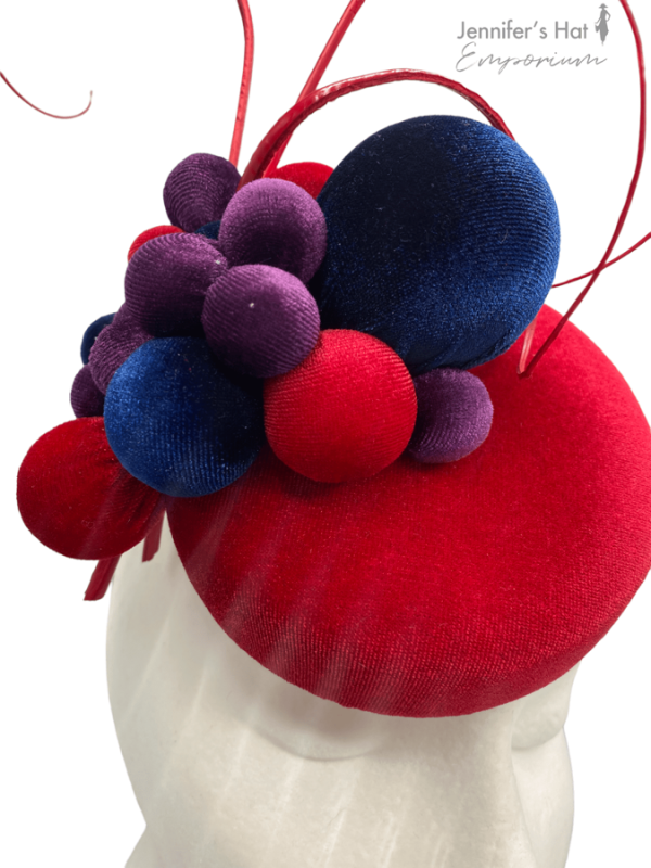 Small smartie sized headpiece with navy and purple ball detail.