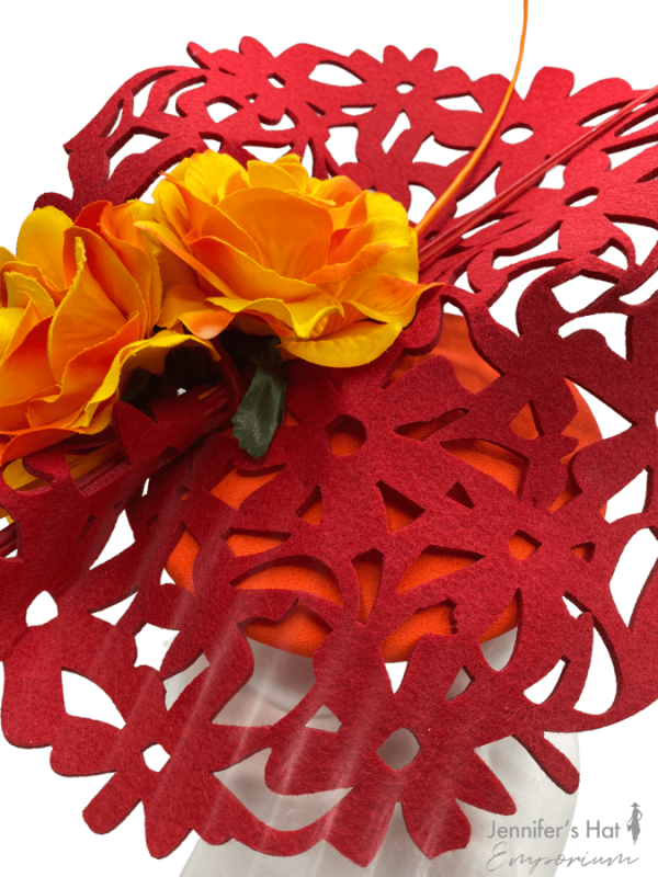 Red laser cut headpiece with orange base, perfect hat for colour clashing.