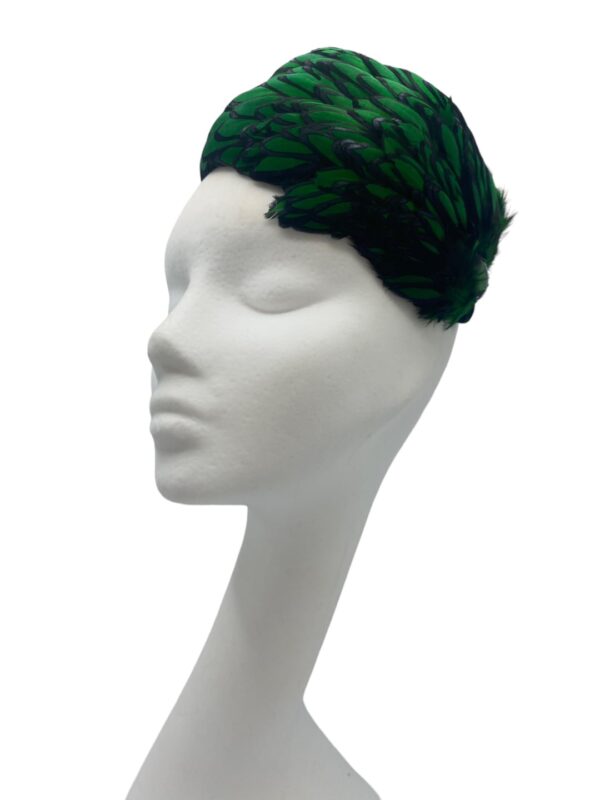 Stunning emerald green and black feather crown with little jewel detail to finish.