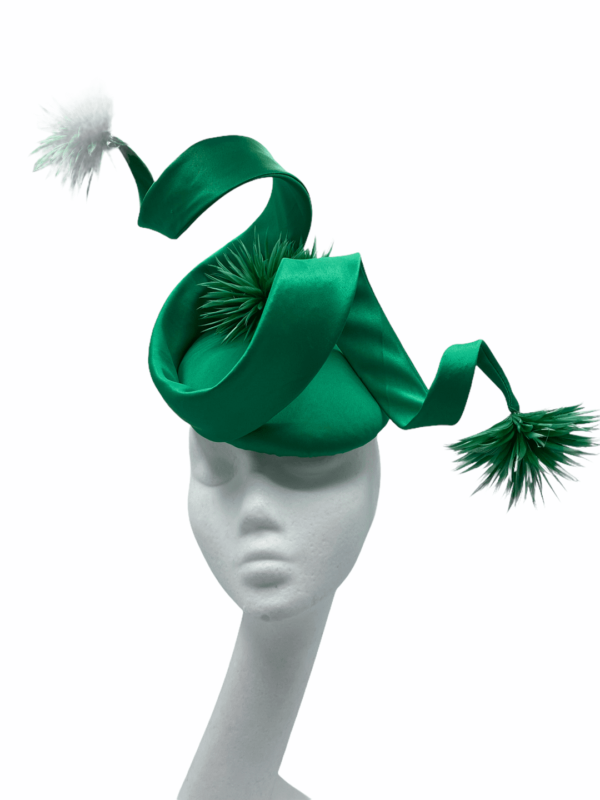 Stunning emerald green satin swirl detail showstopper headpiece.