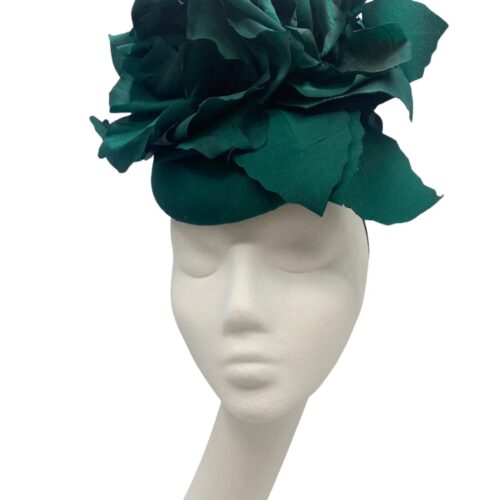 Stunning forest green headpiece with handmade silk flower detail.